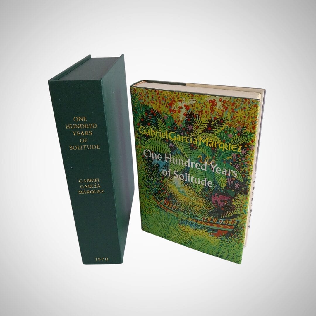 This shows the spine of the book 'one hundred years of solitude', and the front cover of the book. The cover has shades of green and foliage.